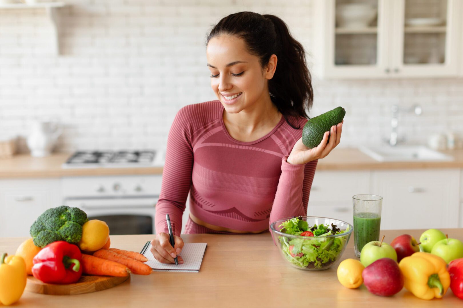 Woman planning meals with fresh vegetables.