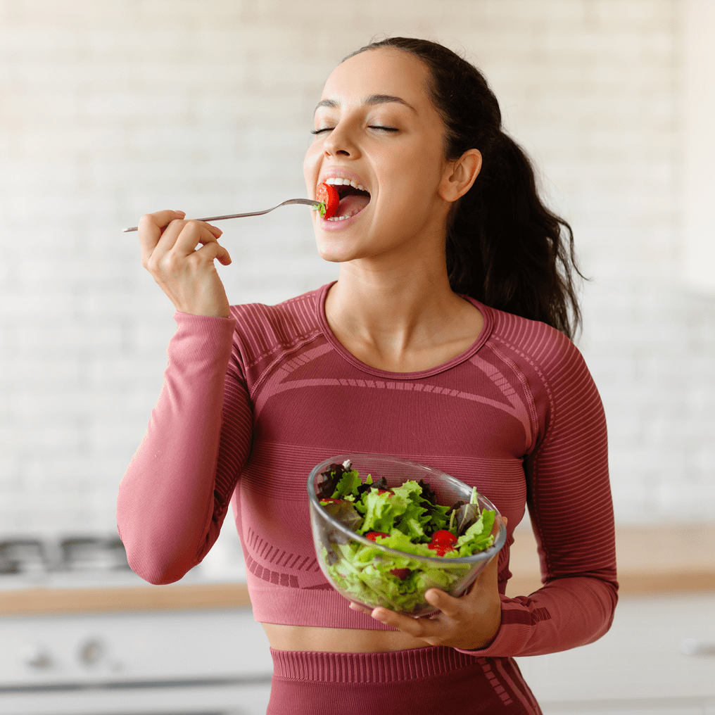 Woman eating a healthy meal as part of a weight loss program.
