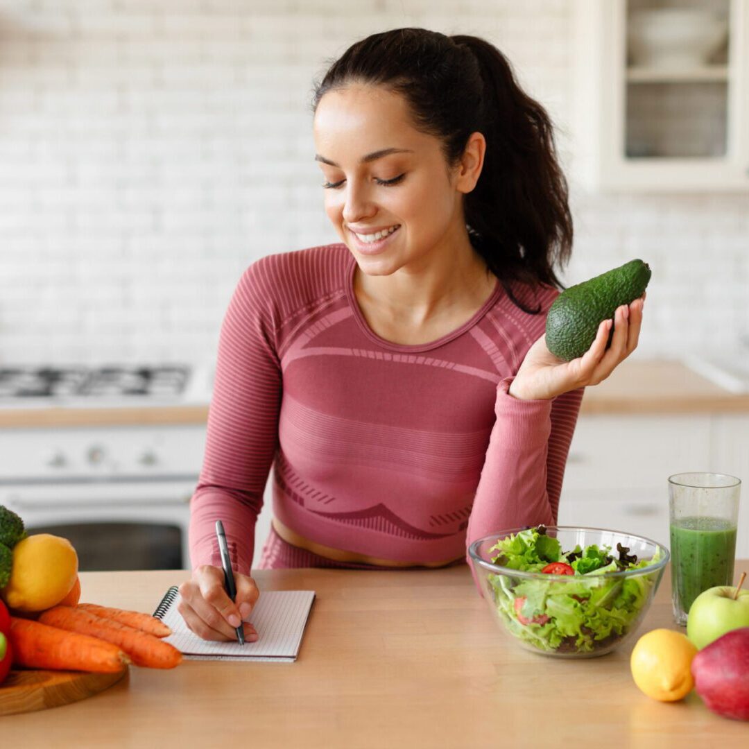 Woman planning meals with fresh vegetables.
